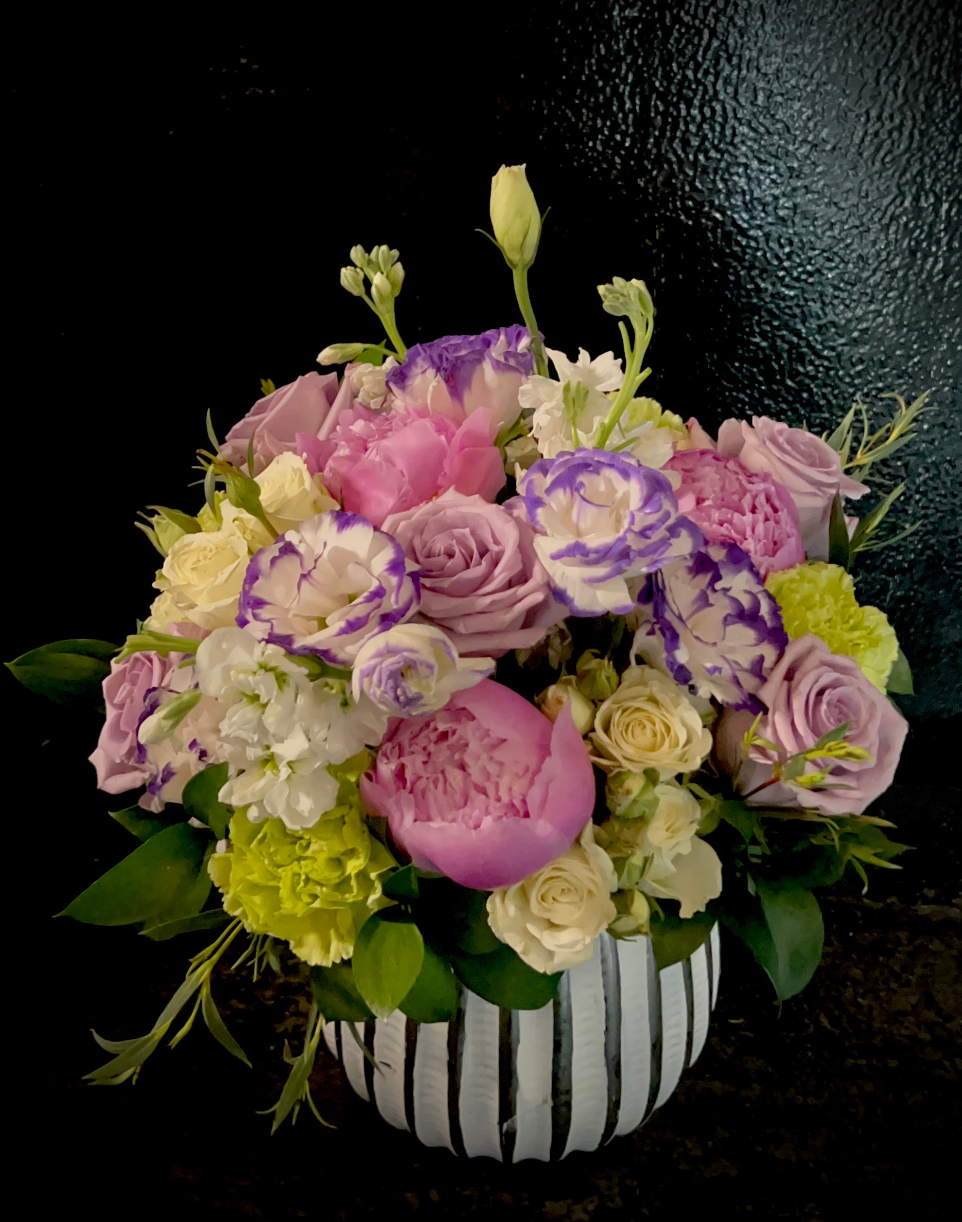 seasonal mix of premium blooms in a ceramic pot.