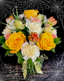 Moderate sized vase arrangement with halloween themed flowers and embellishments.