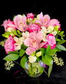 Roses, cymbidium orchids and seasonal blooms mix.