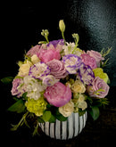 seasonal mix of premium blooms in a ceramic pot.
