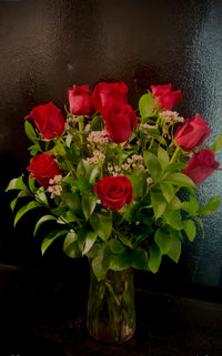 One dozen roses in a vase