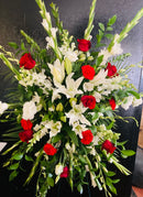 Red and white mixed floral standing spray, sympathy piece.